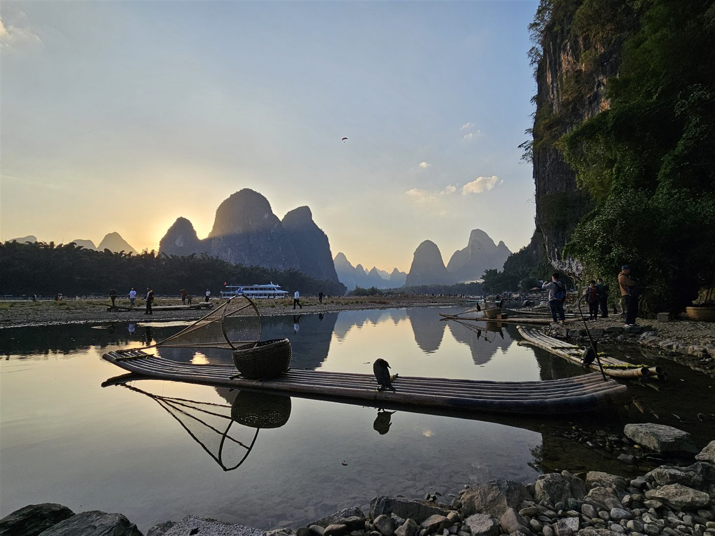 Fishing rafts on the Li River at dusk, karst mountains behind